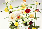 Rose jam on bamboo rack decorated with roses and moss