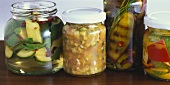 Several jars of pickled aubergines and courgettes