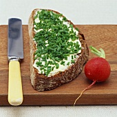 A slice of bread and butter with chives