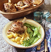 Lamb shanks cooked in Römertopf with potatoes and beans