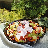 Fruit salad and mascarpone cream with raspberries