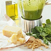 Fresh pesto in blender, pesto ingredients in front