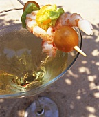 Prawns on cocktail stick on rim of cocktail glass
