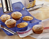 Dusting muffins with icing sugar