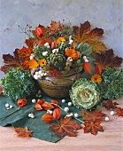 Autumn arrangement of artichokes, ornamental cabbage & marigolds