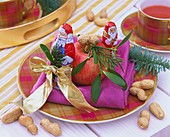 Chocolate Father Christmases, apple & peanuts (plate decoration)