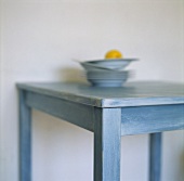 Lemon on stacked plates on a kitchen table