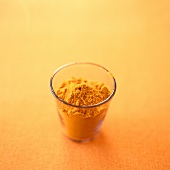 Ground turmeric in a glass