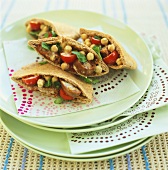 Pita bread filled with chick-peas, sausage and tomatoes