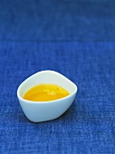 Hazelnut oil in a small white porcelain bowl