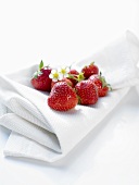Several strawberries on a cloth