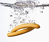 A pair of frankfurters falling into water