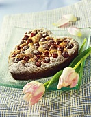 Heart-shaped cherry cake with icing sugar