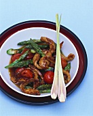 Pork with asparagus, cherry tomatoes and lemon grass