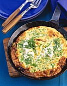 Omelette with peas, dried tomatoes and feta cheese