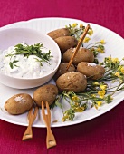 Potatoes in their jackets with ricotta and rocket dip