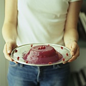 Young woman holding pomegranate jelly