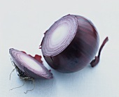 A red onion with a slice cut off