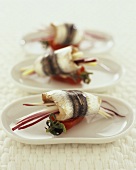 Anchovy rolls with radicchio and tomatoes