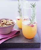 Cocktails with cranberries & rosemary & small dish of nuts