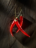 Three chillies on wood