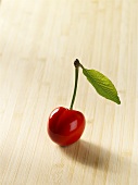 A cherry on a wooden background