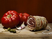 Italian still life: tomatoes, capers, garlic and coppa