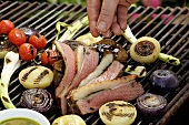 Saddle of lamb on barbecue with sage pesto & grilled onions
