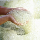 Hands holding soap foam