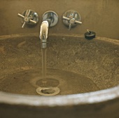 Water running from a tap into a wash basin