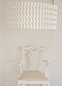 A white chair under a light