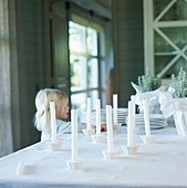 Little girl arranging candles on a table