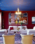 Living room with white sofa combination, large wall hanging with Chinese motif, gilt stars on ceiling and Chinese silk rug