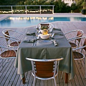 Set table next to pool in garden