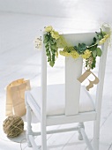 Garland of plants on chair backrest