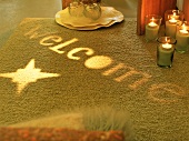 Candles and lights shining on rug