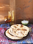 Several naan breads on a plate