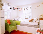 Child's bedroom with bed in corner, whimsical bed linen and bright accents of colour