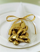 Gold chocolate dragées (Christmas table decoration)