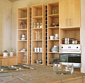 Kitchen with wooden shelves, cooker and island counter
