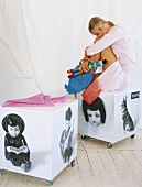 Girl sitting on toy box on castors