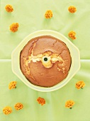 A cake in a baking mould decorated with an eye