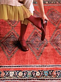 Feet on red rug