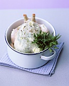 Raw herb chicken in a roasting dish
