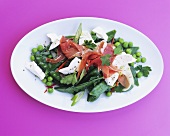 Mangetout and pea salad with ham and goat's cheese