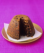 Christmas pudding with a portion taken (UK)