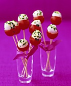 Cocktail tomatoes stuffed with mozzarella on cocktail sticks