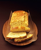 Cornbread, partly sliced, on wooden board