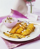 Fried pineapple with almonds and pistachios