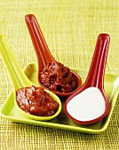 Barbecue sauce, harissa sauce and Roquefort sauce in spoons